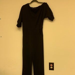 Black jumpsuit with one off the shoulder look